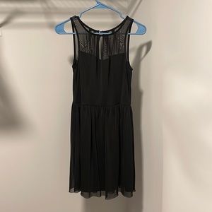 Black cocktail dress with sweetheart neckline and mesh top. Size S.